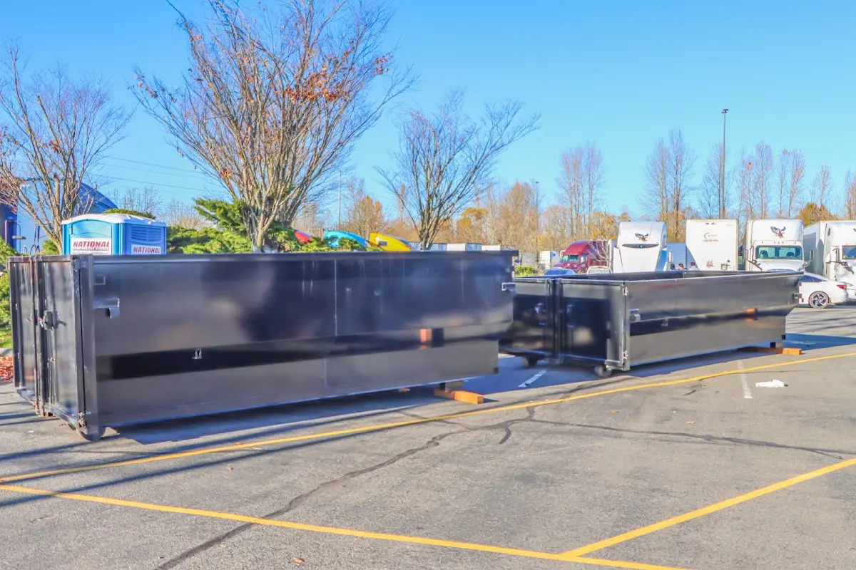 Professional dumpster rental service with roll-off container on residential driveway in Elm Grove